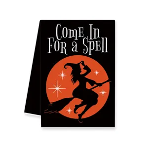 Halloween witch dish towel, black and orange spooky kitchen cloth for holiday cleaning.