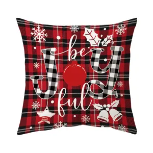 Red black plaid Christmas throw pillow cover with festive JOY text and snowflakes design.