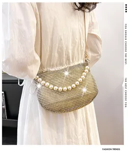Detailed view of a fashionable rhinestone shoulder bag with elegant pearl handle for women.