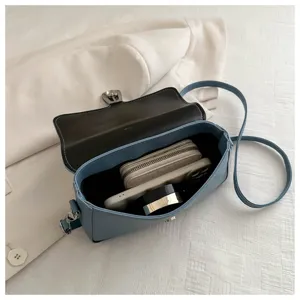 Detail view of the light blue leather crossbody bag showing internal capacity and neat structure.