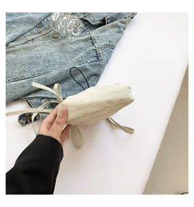 Minimalist nylon bucket shoulder bag for women, casual crossbody bag with drawstring.