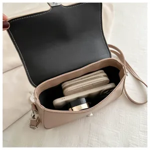 Interior detail of beige crossbody bag showing ample capacity and neat organization compartments.