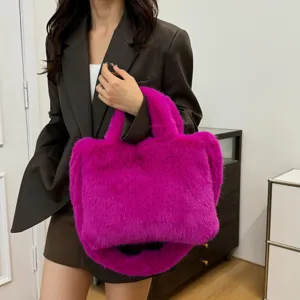 Detail view of hot pink fluffy plush handbag, soft faux fur tote bag for women stylish use.