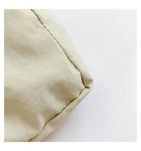 Close-up detail of the minimalist nylon bucket bag featuring fine stitching texture.