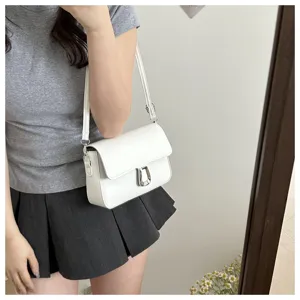 White minimalist retro crossbody shoulder bag detail showing stylish design and metal lock.