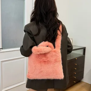 Chic pink fluffy plush shoulder bag for women, cozy faux fur crossbody tote for autumn.
