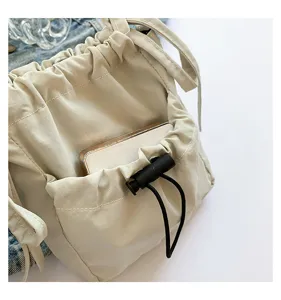 Casual nylon bucket bag for women, simple solid color crossbody shoulder bag with drawstring.