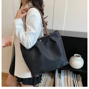 Casual minimalist black nylon tote bag for women, lightweight single-shoulder underarm bag.