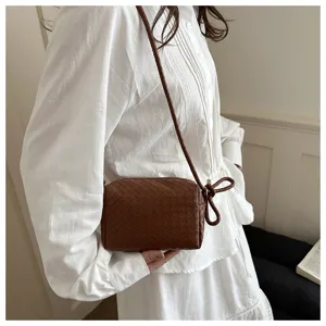 Brown woven leather crossbody bag, stylish women's shoulder bag with chic knot accent.