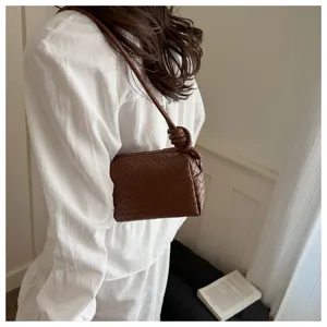 Chic brown woven leather shoulder bag with stylish knotted strap for women daily casual wear.