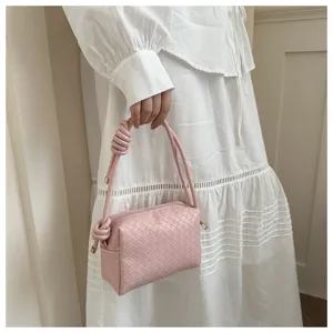 Pink woven leather shoulder crossbody camera bag with stylish knotted top handle design for women.