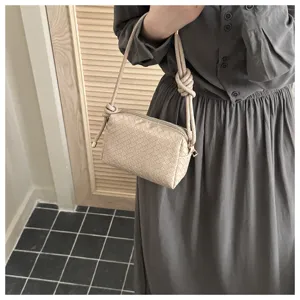 Beige woven camera bag detail, stylish crossbody shoulder bag with unique knot strap design