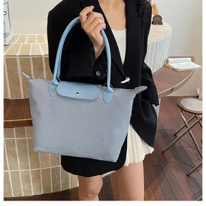 Light blue mesh tote bag detail featuring leather flap, double top handles, and snap closure.