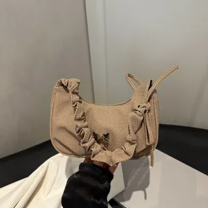 Chic pleated canvas shoulder bag with elegant ruffle design and cute butterfly charm for women.