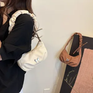 Chic ruched shoulder bag for women, trendy underarm handbag with cute silver butterfly decor.