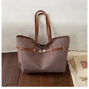 Detailed view of the vintage textured fabric tote bag with elegant brown leather handles.