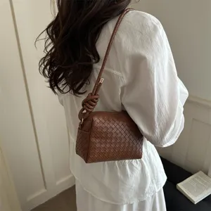 Chic woven leather shoulder crossbody bag for women, stylish brown handbag with knot handle.
