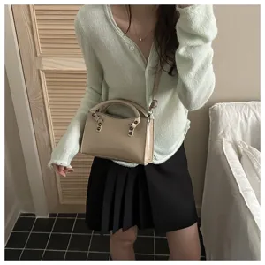 Stylish retro shoulder bag and commuter crossbody handbag detail view, elegant daily outfit.