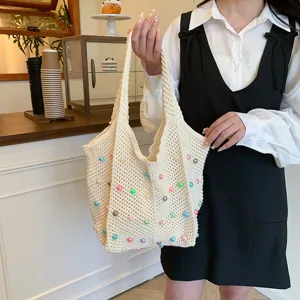 Beige woven crochet tote bag with colorful beaded floral accents for women seaside commute.