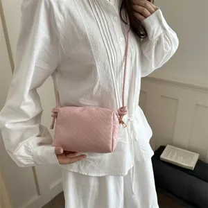 Stylish pink woven crossbody shoulder bag, chic camera bag for women daily casual wear.