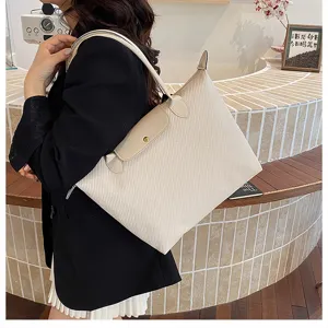 Beige woven texture shoulder tote bag with leather flap for women commuter daily use detail view.