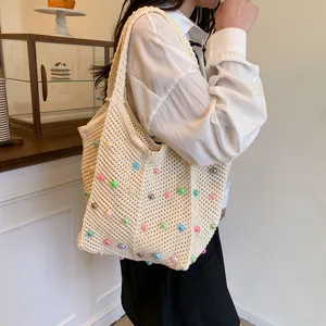 Detailed view of beige woven tote bag with colorful beads, perfect for daily casual look.