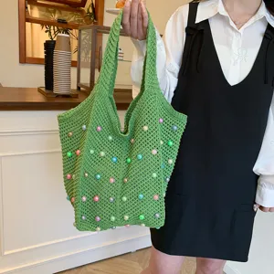 Detailed close-up view of green crochet shoulder tote bag with colorful pearl beads.