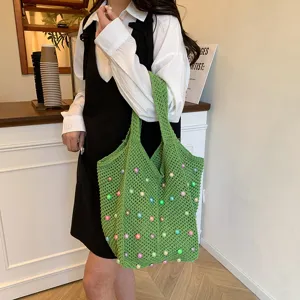 Detailed view of green crochet tote bag with colorful beads, perfect for daily commuting style.