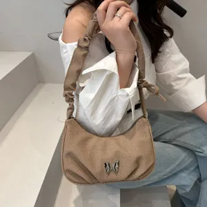 Stylish women brown shoulder bag with scrunchie strap and silver metal butterfly charm daily use
