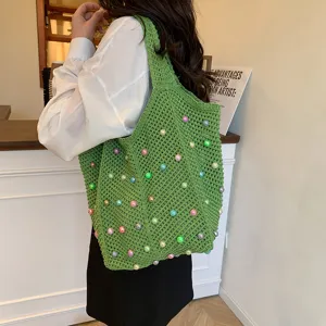 Green crochet tote bag with colorful beads, stylish knitted shoulder bag for women, beach vacation.