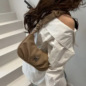 Brown pleated shoulder bag with silver butterfly accent, chic casual underarm bag for women.