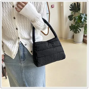 Detailed view of the black quilted nylon underarm bag, casual style, chic and light.