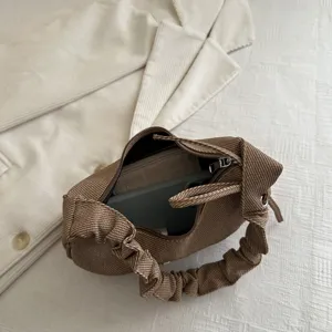 Stylish brown pleated shoulder bag for women, trendy niche underarm handbag displayed flat.