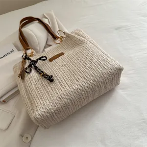Casual minimalist straw tote bag for women, stylish woven shoulder handbag for beach vacation.