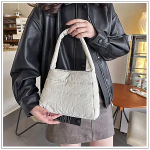 Detailed view of the stylish quilted nylon underarm shoulder bag in casual solid beige style.