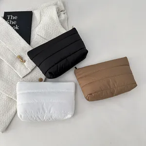 Minimalist quilted clutch bag for women, stylish puffer makeup pouch and casual handbag.