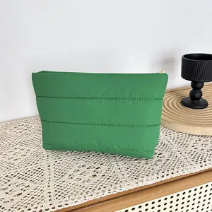 Green quilted pouch minimalist cosmetic bag fashion casual clutch for women daily commuting.
