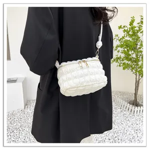 Detailed view of the white quilted cloud shoulder bag, featuring soft crinkled texture and chic style.