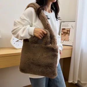 Brown fluffy faux fur tote bag for women, cozy winter shoulder bag with soft plush handles.