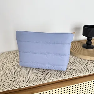 Detail view of light purple quilted cosmetic pouch showing soft texture and neat stitching lines.