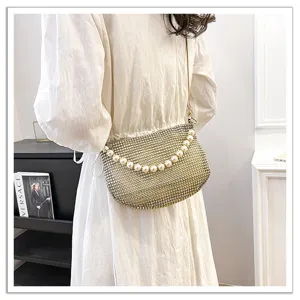 Elegant rhinestone shoulder bag with faux pearl handle, perfect for evening parties.