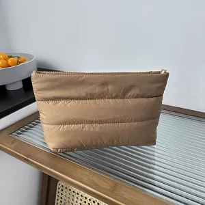 Close-up of a chic quilted khaki padded pouch, perfect as a stylish clutch or cosmetic bag.