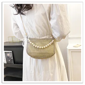 Stunning sparkling rhinestone crossbody bag with elegant pearl chain strap for evening party.