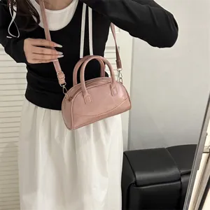 Pink leather Boston handbag for women, stylish crossbody shoulder bag with dual handles.