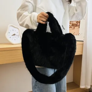 Detail shot of a black fluffy plush handbag, showing soft faux fur texture and comfortable handle.