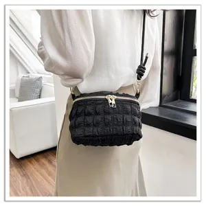Chic black crinkled mini cloud crossbody bag detail shot, stylish shoulder handbag for women.