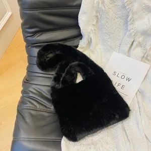 Stylish black faux fur handbag for women, fluffy plush shoulder tote bag for winter daily wear.