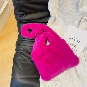 Close-up shot of a vibrant pink fluffy plush handbag showcasing soft texture and stylish design.