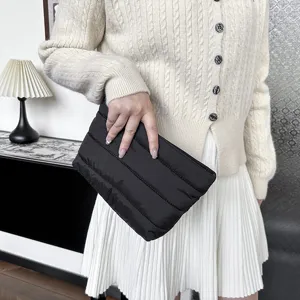 Black quilted clutch bag for women, minimalist padded puffer pouch, stylish evening purse.