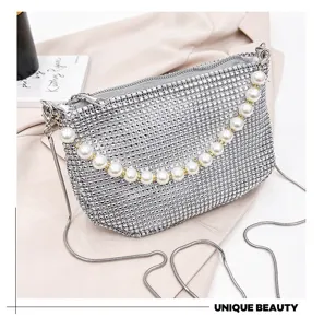 Detailed view of the sparkling rhinestone shoulder bag with pearl handle and metal chain.